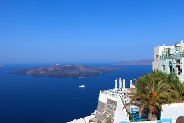 White houses of Fira, Santorini with Santorini's famous volcano in the background