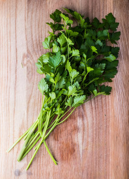 Fresh parsley herbs on wooden chopping board