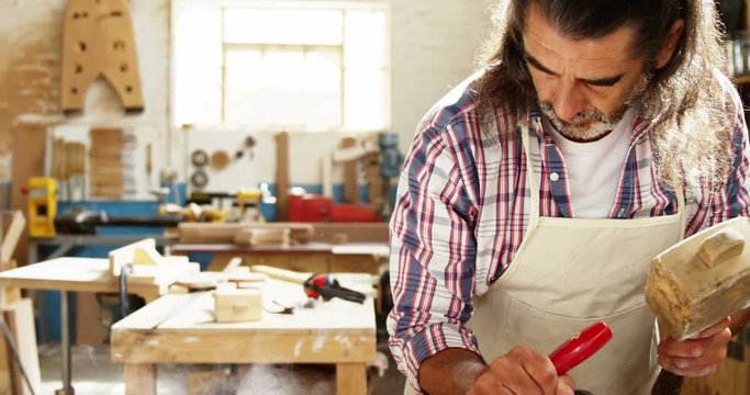 Carpenter using hammer and chisel 