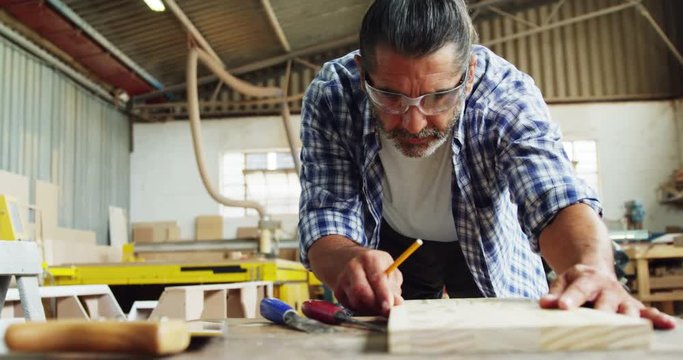 Facing view of carpenter focused while working