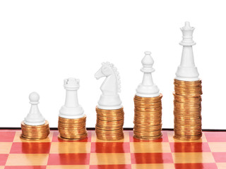 Business concept with chess and coins on a chess board