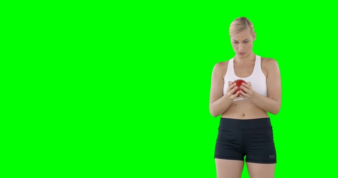 Athlete woman practicing shotput front of a green screen