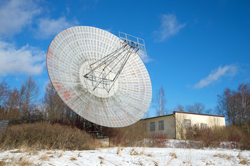 The radio telescope at the building of the astrophysical laboratory of the sunny february day....
