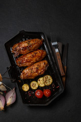 Chicken grilled on a black grill pan. horizontal view from above