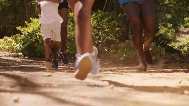 Family is running together in a park 