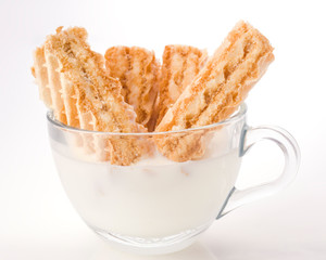 biscuit dipped in milk glass cup