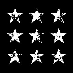 Obraz premium Star icons with grunge texture set. Vintage retro style. Design elements. White silhouette, isolated on black background. Grungy artistic template. Distressed symbol. Paint brush. Vector illustration