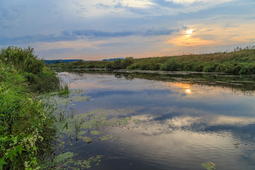 Fototapeta na wymiar Sunset over the young Russian river, summer landscape
