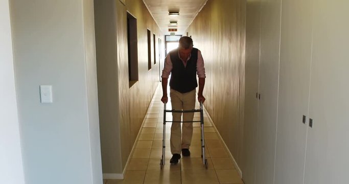  Patient walking with zimmer frame on medical office