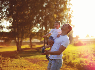 Fototapeta premium Happy father and son child having fun together, enjoying sunny s