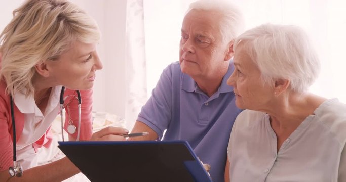 Female doctor consulting to a senior couple