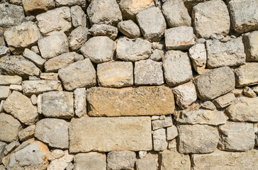 Traditional wall of stones built without lime. Dry stone wall.