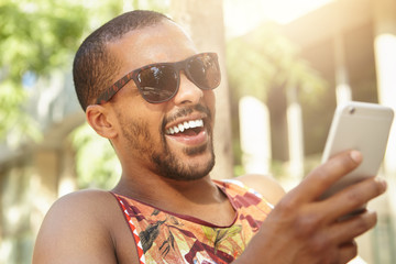 Fashion lifestyle concept. Close up portrait of happy cheerful attractive laughing black man in...