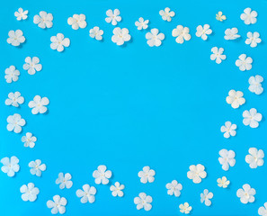 beautiful wreath white flowers on blue background, close up