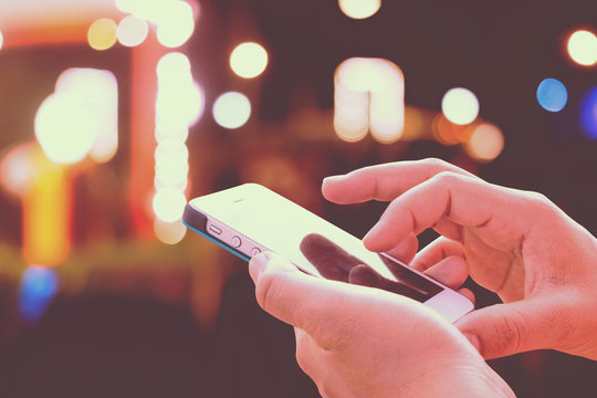 Close up of male hands hoding modern smart phone , woman's hand