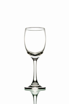Glass with mirror reflection on white background