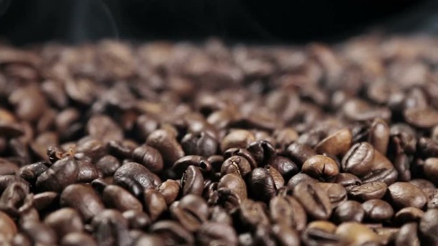 preparing roasted coffee beans with smoke. dolly shot