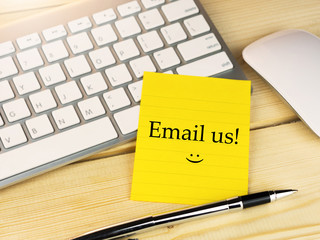 Email us on sticky note on work desk