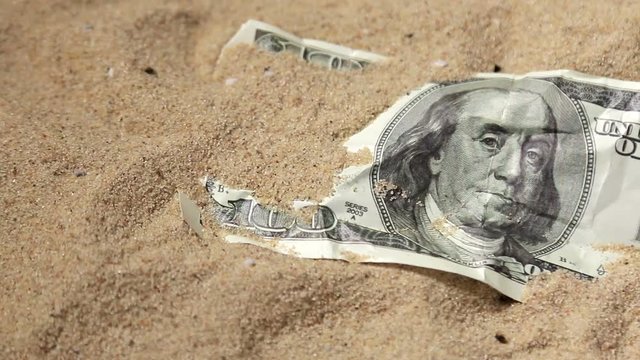 100 dollar bill in the sand in the desert. shot slider