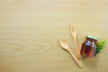 honey bee ,fork and spoon with copy space on wood background.