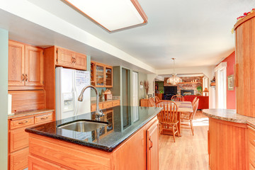 Bright kitchen interior with oak wood cabinetry