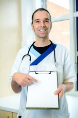 male nurse pointing at a clipboard