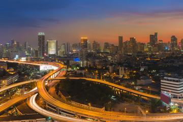 Sunset background over city downtown and highway interchanged