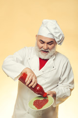 Bearded cook with ketchup bottle