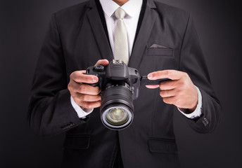 Young photographer man holding camera