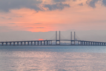 Fototapeta na wymiar Sunrise by the shore with view of Penang Bridge