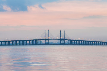 Fototapeta na wymiar Sunrise by the shore with view of Penang Bridge