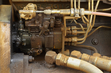 Old engine of grader car with oil engine leak