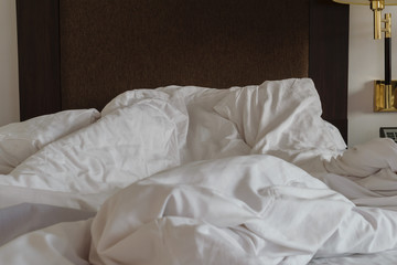 Fototapeta na wymiar Messy bedding sheets and pillow