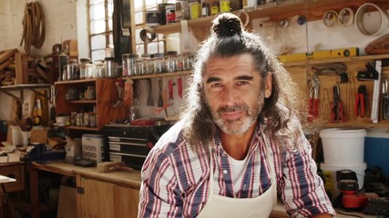 Attractive carpenter smiling while working