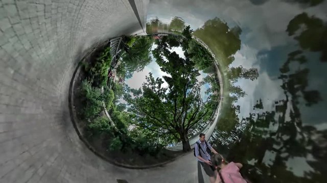 360Vr Video Man and Kid by Rippling Water Walking by Edge on Parapet by Water in Park Alley Made With Paving Tiles Family Spend Time Together in Summer 360Vr Video