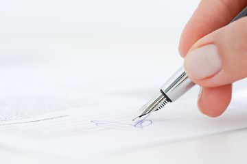 Sign a contract or agreement with an ink pen
