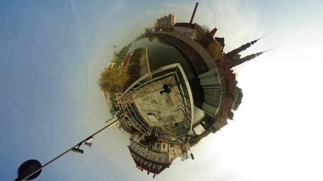 People Walking by Old City on a River Bank vr Video 360 Little Planet Video Two Towers of a Cathedral Vintage Buildings Cityscape Floating Clouds Blue Sky