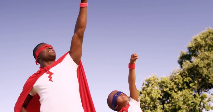 Man playing with his son in costume of superheroes