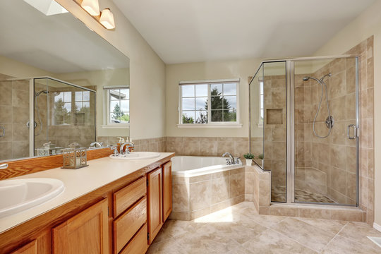 Master bathroom with corner bathtub and tile floor
