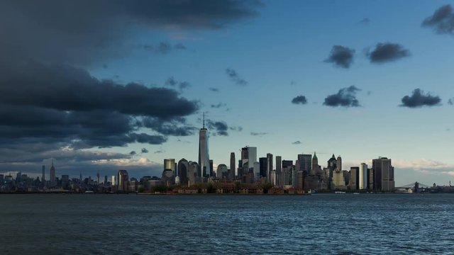 New York City Lower Manhattan cityscape time lapse video with afternoon rain storm. View of  Financial District skyscrapers, Midtown West and Ellis Island