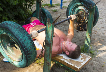 Naklejka premium Portrait of a young athletic man in the street the gym