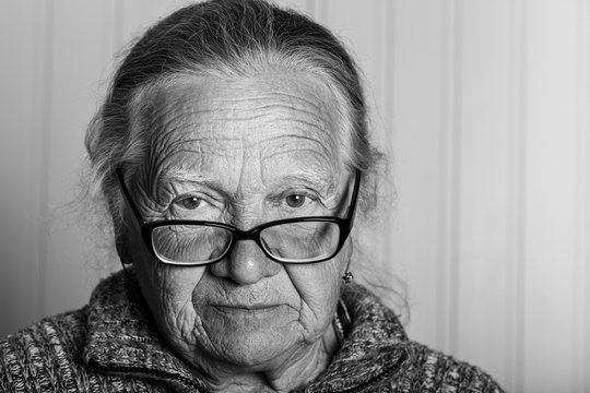 Portrait of elderly woman in glasses. Toned