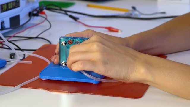 Student teen girl experiment PEM proton exchange membrane reversible fuel-cell