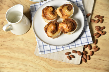 Almond danish cupcakes on wooden table.