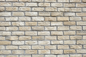 Wall from beige bricks front view closeup horizontal photo