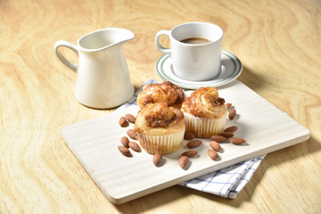 Almond danish cupcakes on wooden table.