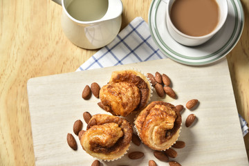 Almond danish cupcakes on wooden table.