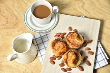 Almond danish cupcakes on wooden table.