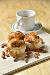 Almond danish cupcakes on wooden table.