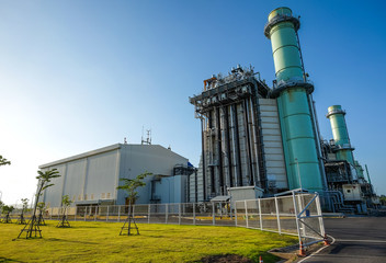 Combine cycle power plant with green field and clear sky